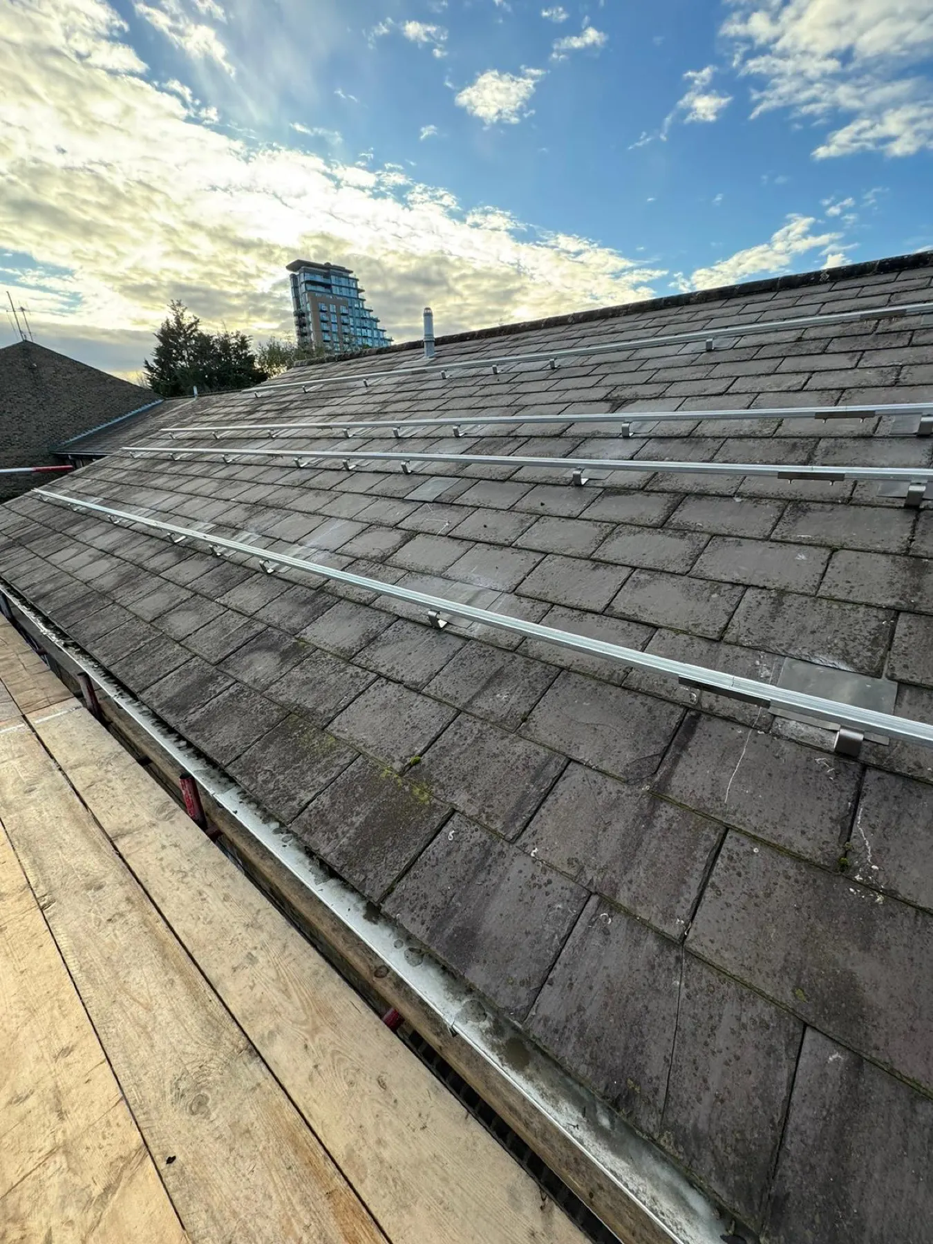 A London rooftop mid-installation, with the city skyline behind